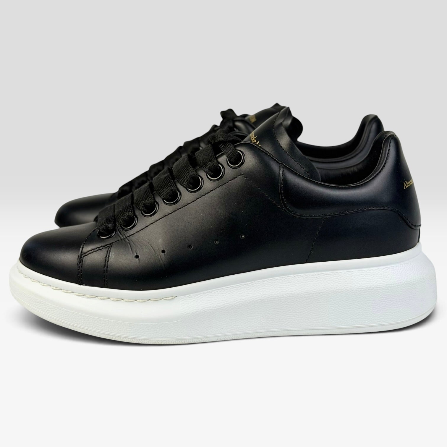 V STEALS Alexander McQueen black leather oversized sneakers with thick white rubber sole and rounded toe