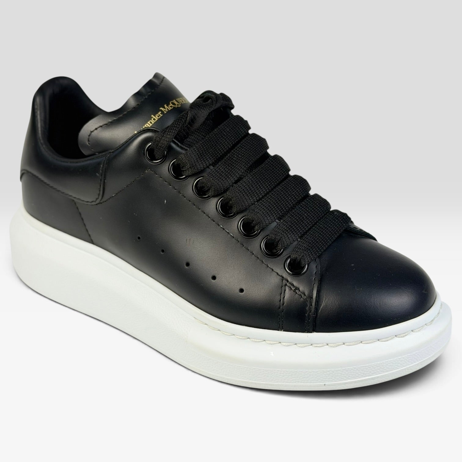 V STEALS pre-loved Alexander McQueen black leather oversized sneakers with thick white rubber sole and round toe