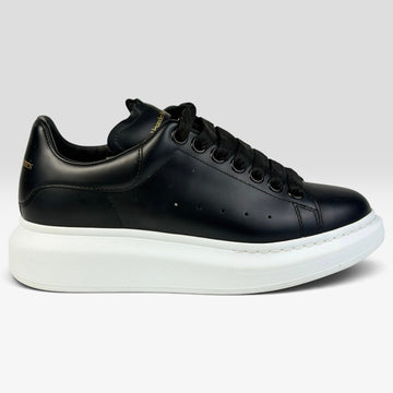 V STEALS Alexander McQueen black leather oversized sneakers with a thick white rubber platform sole and round toe.