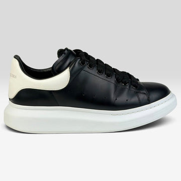 V STEALS pre-loved Alexander McQueen oversized sneakers in black leather with a chunky white rubber sole
