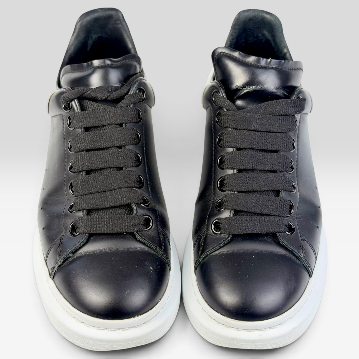 V STEALS Alexander McQueen black leather oversized sneakers with thick white rubber soles and rounded toes