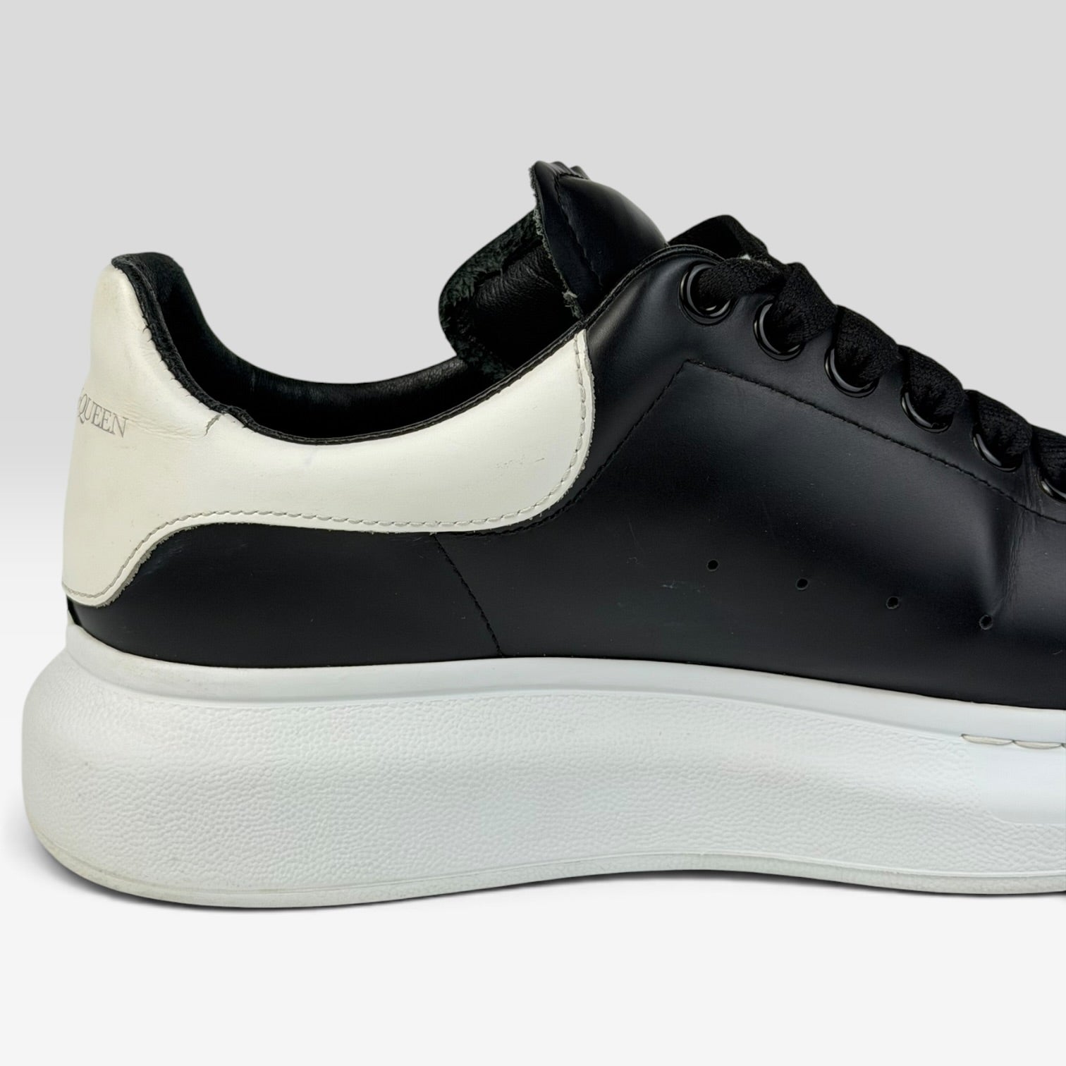V STEALS Alexander McQueen black leather oversized sneaker with white rubber platform sole and heel tab detail