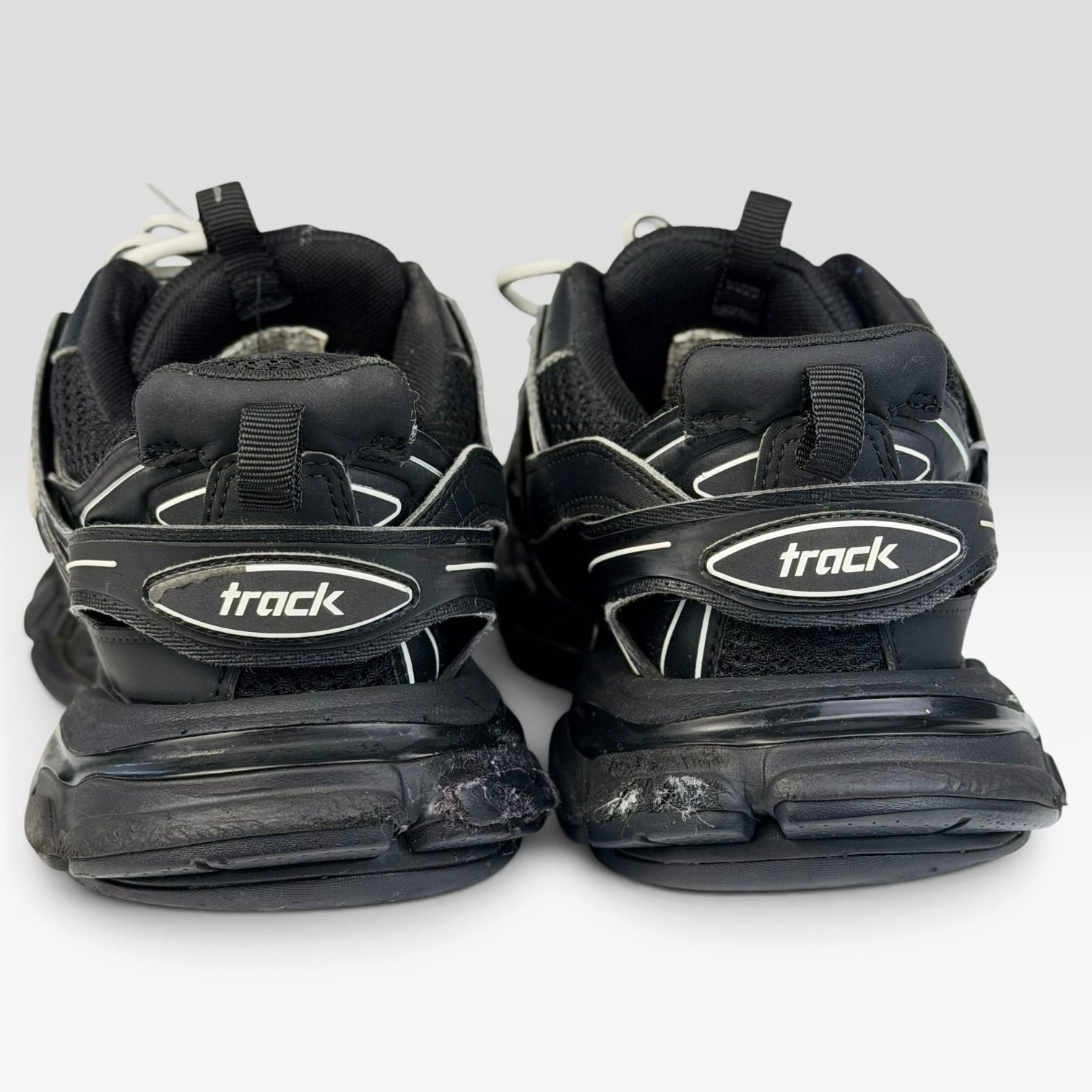 V STEALS pre-loved black Balenciaga Track sneakers showing rear view with chunky lug soles and track branding