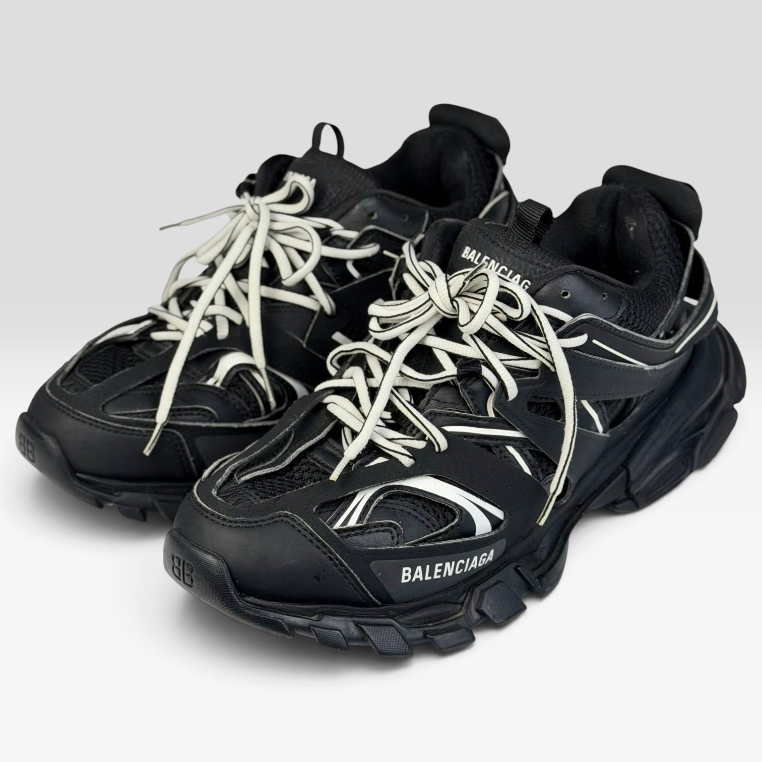 V STEALS Balenciaga Track sneakers in black mesh with layered caging, white-accented laces, and chunky lug soles.
