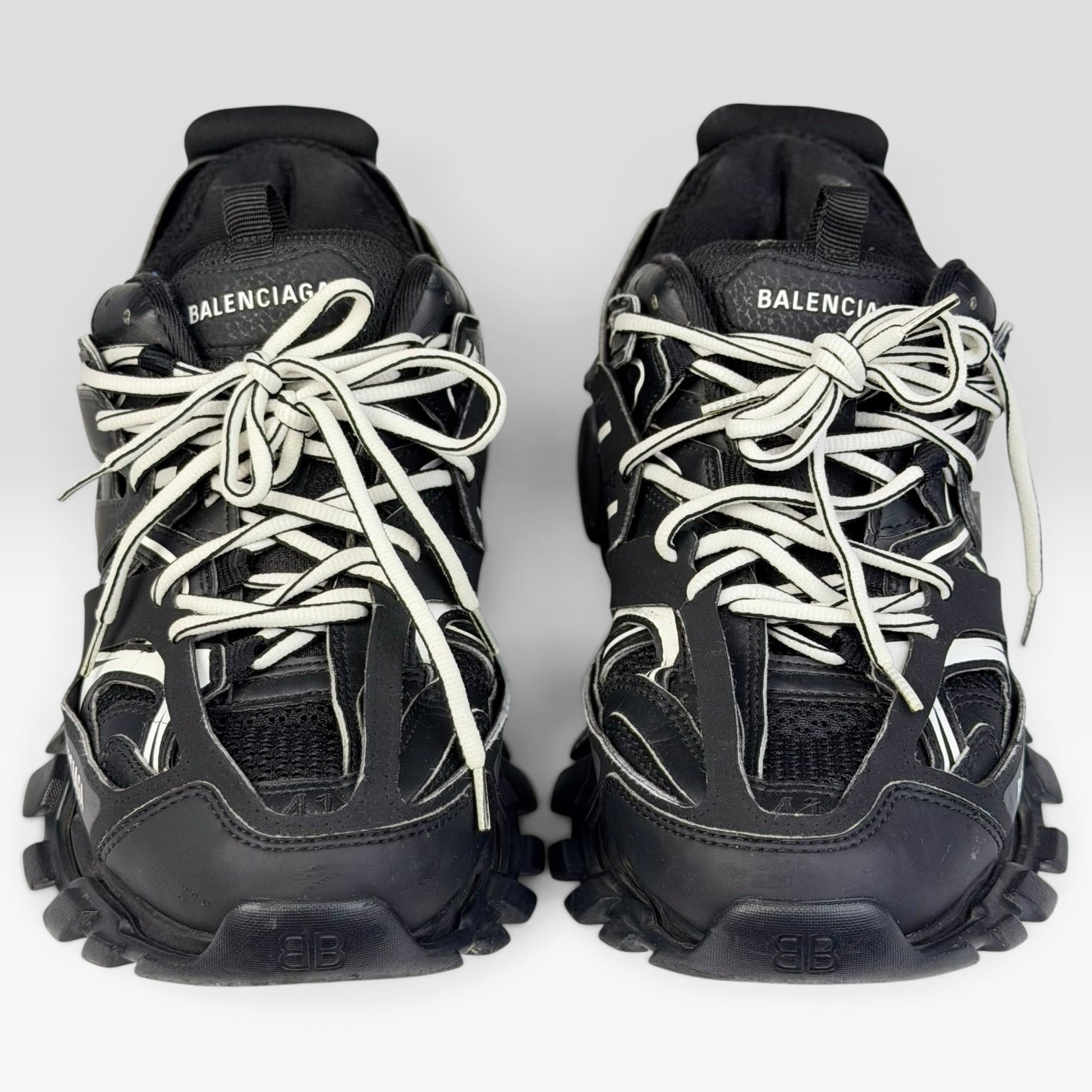 V STEALS Balenciaga Track sneakers in black with technical mesh, layered caging, and white laces, front view.