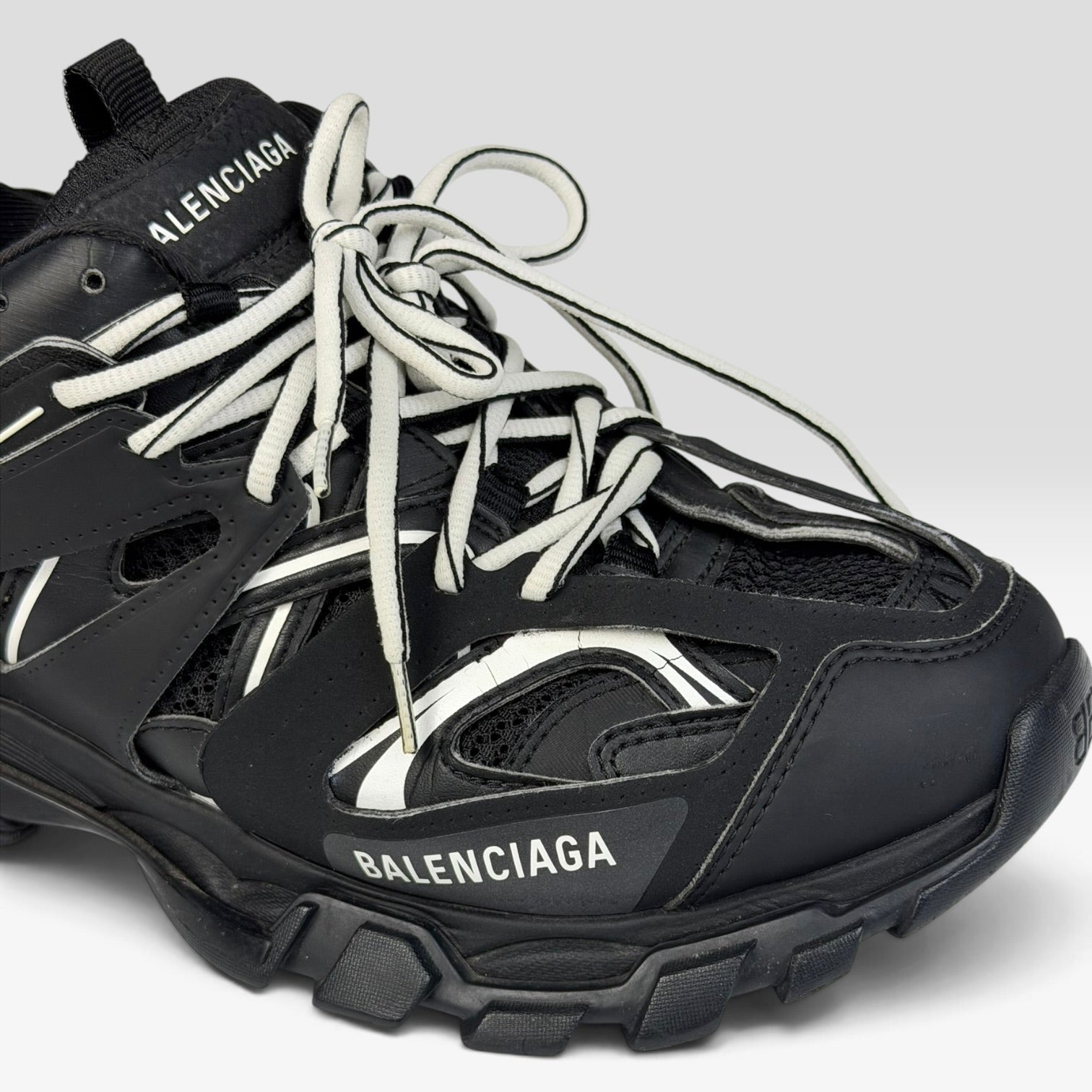 V STEALS pre-loved Balenciaga Track sneakers in black technical mesh with layered caging and white lace details.