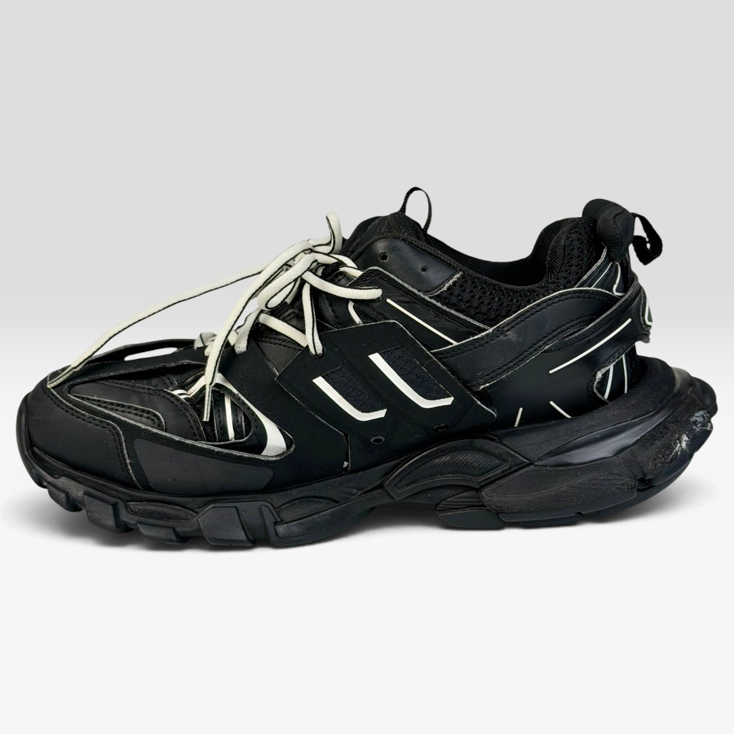 V STEALS pre-loved Balenciaga Track sneakers in all black with technical mesh, layered caging, and chunky lug sole.