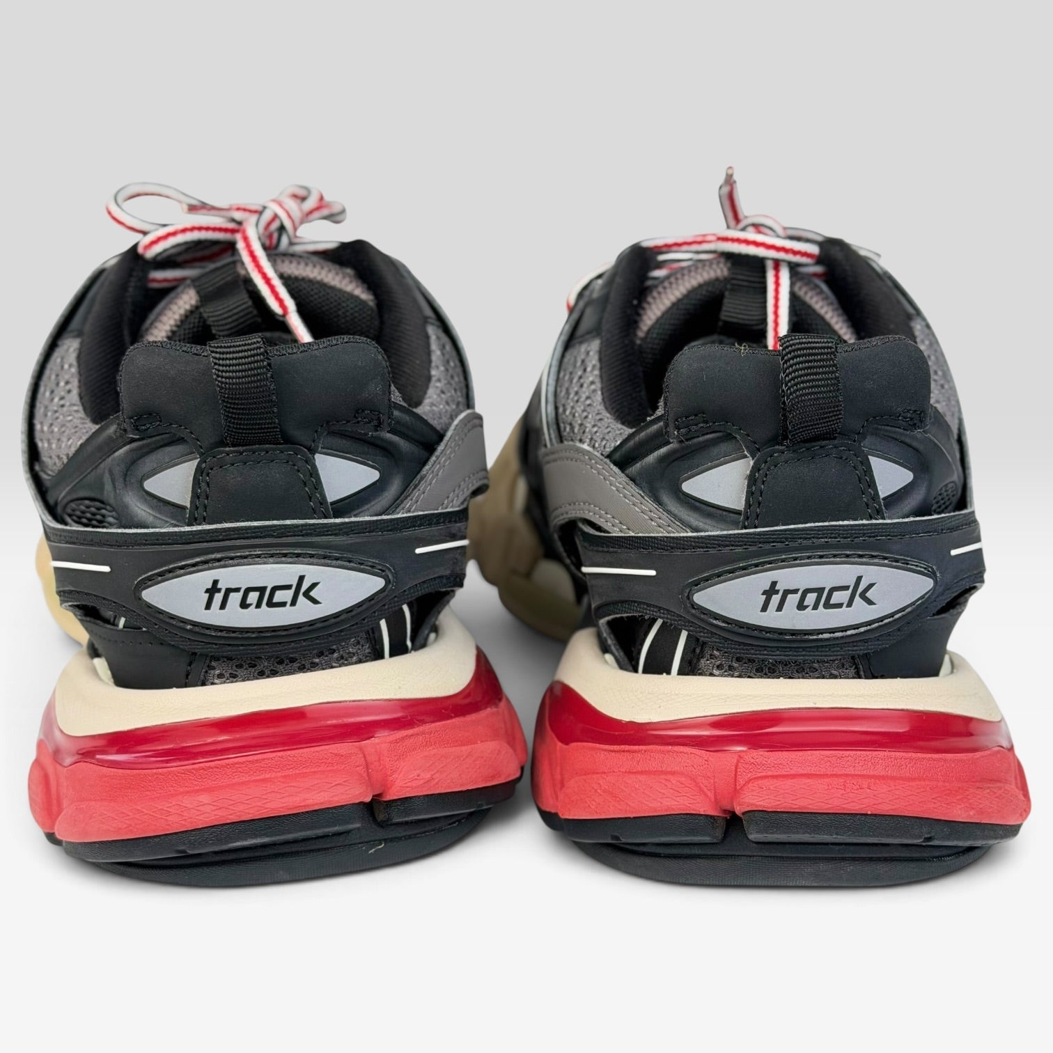 V STEALS Balenciaga Track Bred sneakers in black and red with technical mesh and chunky lug soles, rear view.