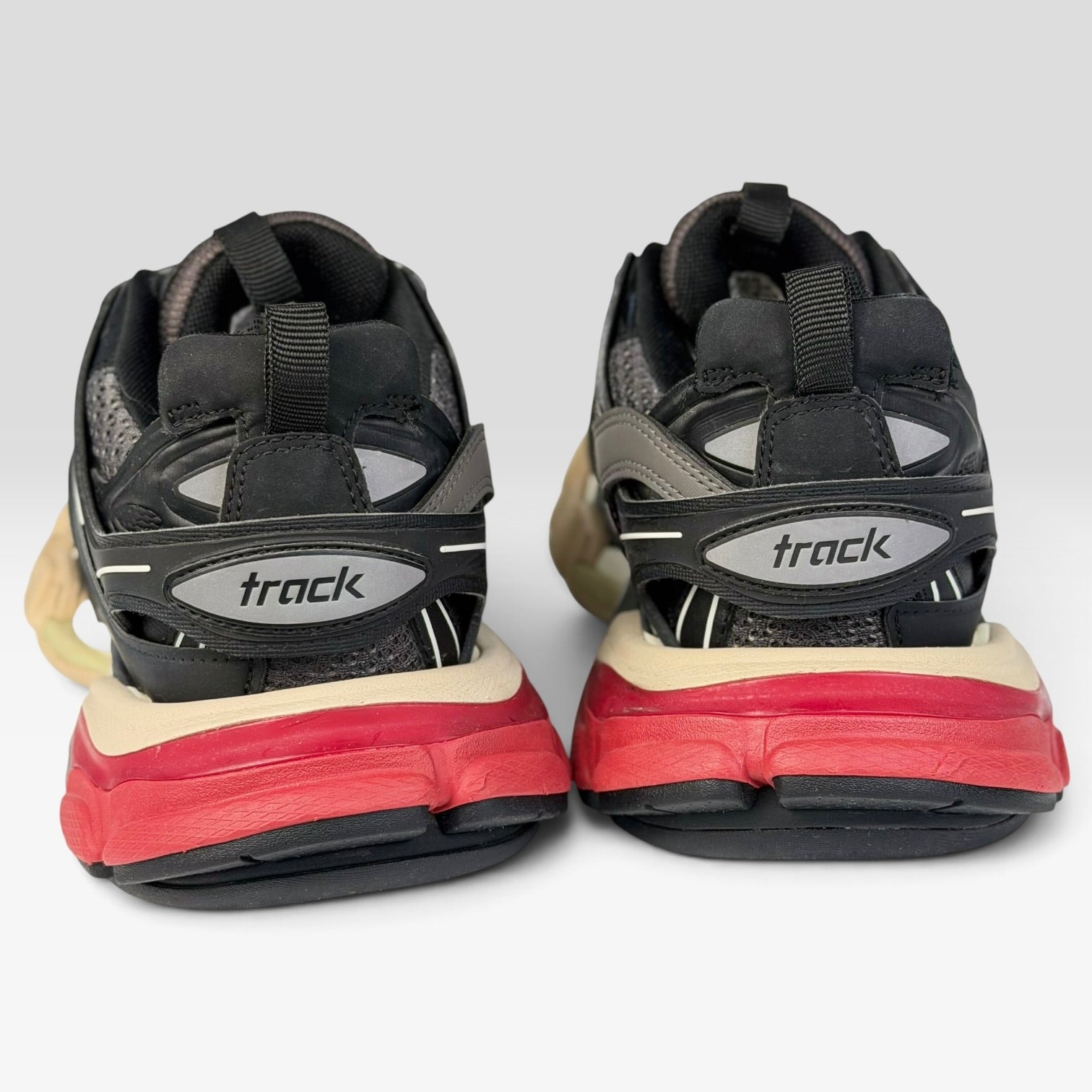 V STEALS Balenciaga Track Bred sneakers in black and red with technical mesh, lugged soles, and rear track branding.