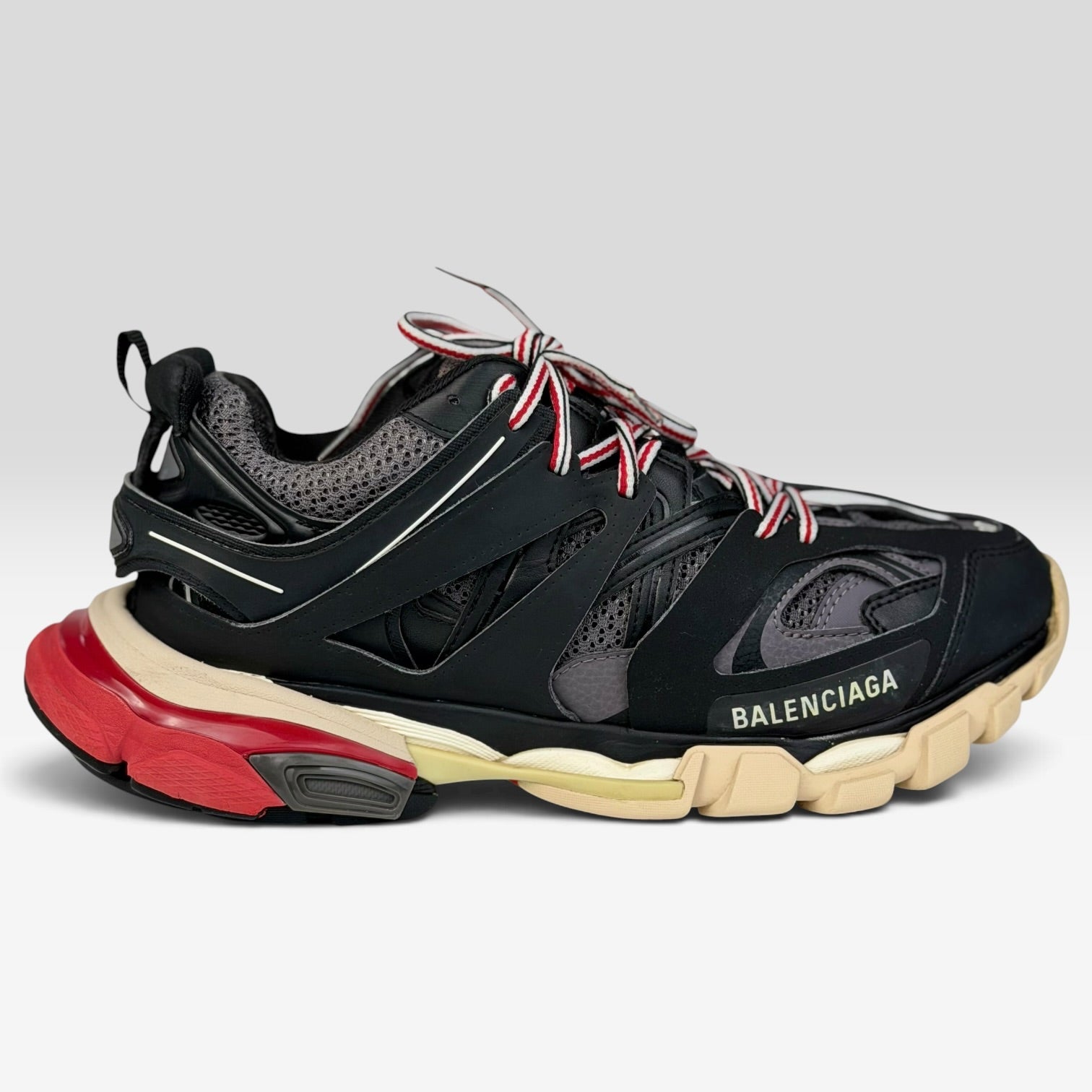 V STEALS Balenciaga Track Bred sneakers in black and red with technical mesh, layered caging, and a chunky lug sole.