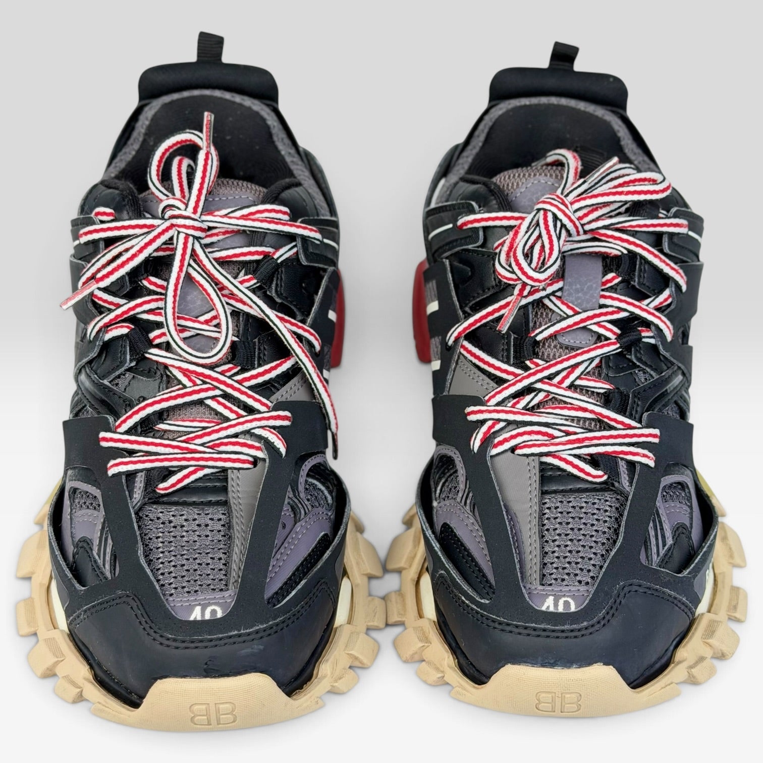 V STEALS Balenciaga Track sneakers in black and red with technical mesh, layered caging, and chunky beige lug soles.