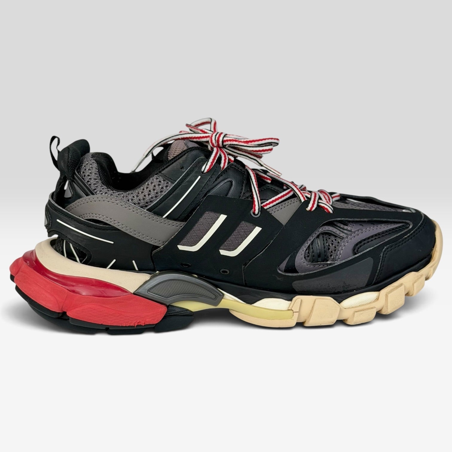 V STEALS Balenciaga Track Bred sneakers in black and red with technical mesh, layered caging, and a chunky lug sole.