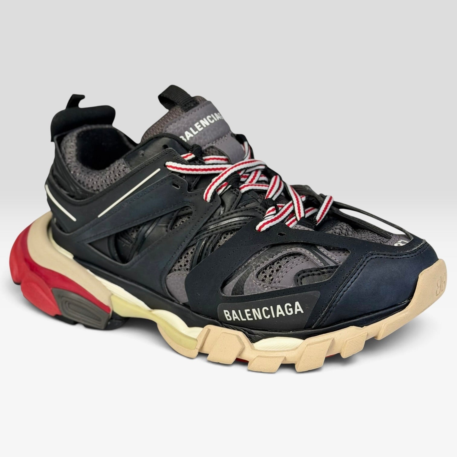 V STEALS pre-loved Balenciaga Track sneakers in black and red with technical mesh, layered caging, and lugged sole.