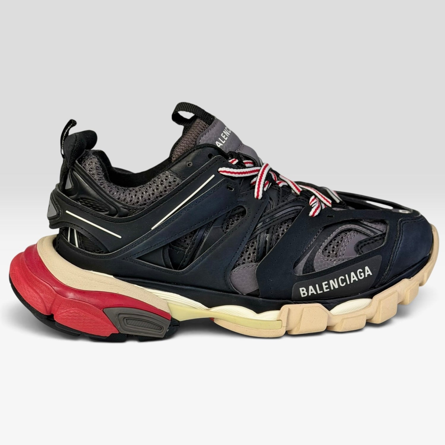 V STEALS Balenciaga Track Bred sneakers in black and red with technical mesh, layered caging, and a chunky lug sole.