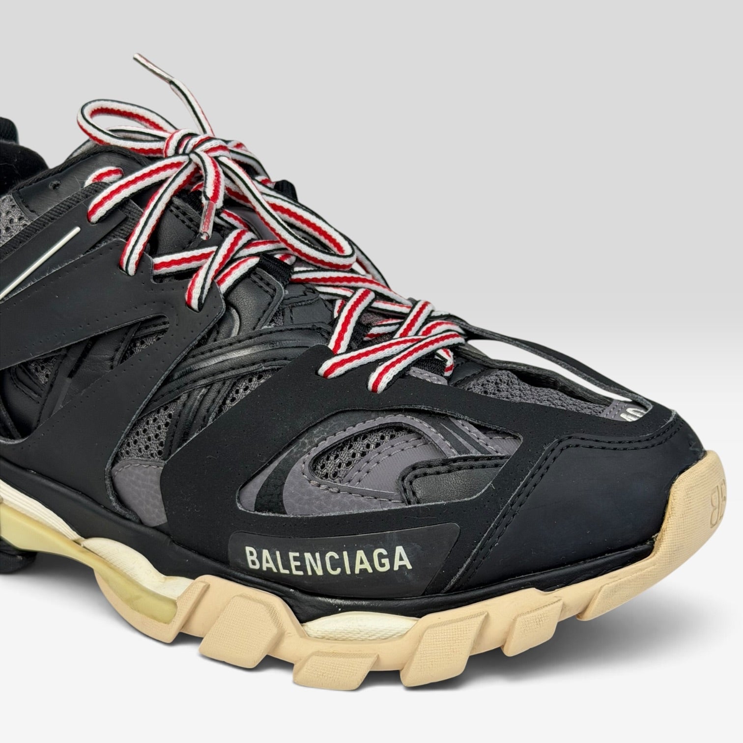 V STEALS Balenciaga Track Bred sneakers in black and red with technical mesh, layered caging, and lugged sole.
