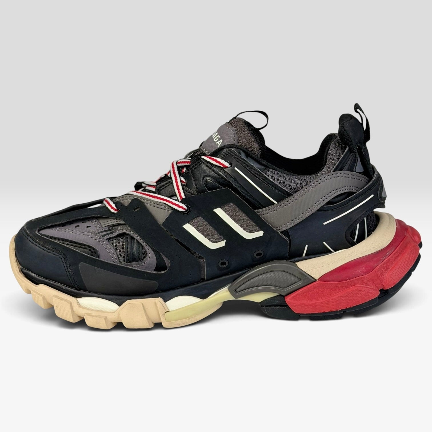 V STEALS Balenciaga Track sneakers in black and red with technical mesh, layered caging, and a chunky lug sole.