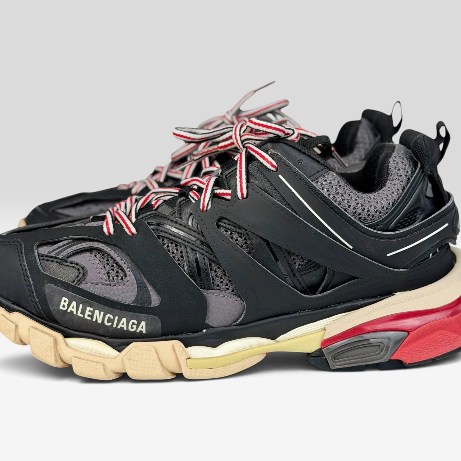 V STEALS Balenciaga Track Bred sneakers in black and red with technical mesh, layered caging, and chunky lug sole.
