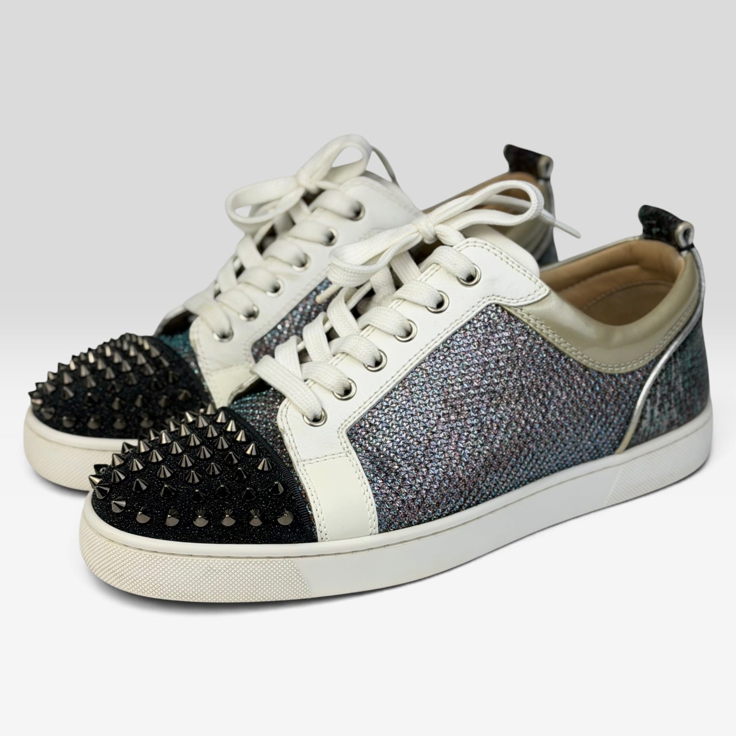V STEALS Christian Louboutin Louis Junior sneakers with multicolor glitter, lizard-embossed leather, and black spikes.