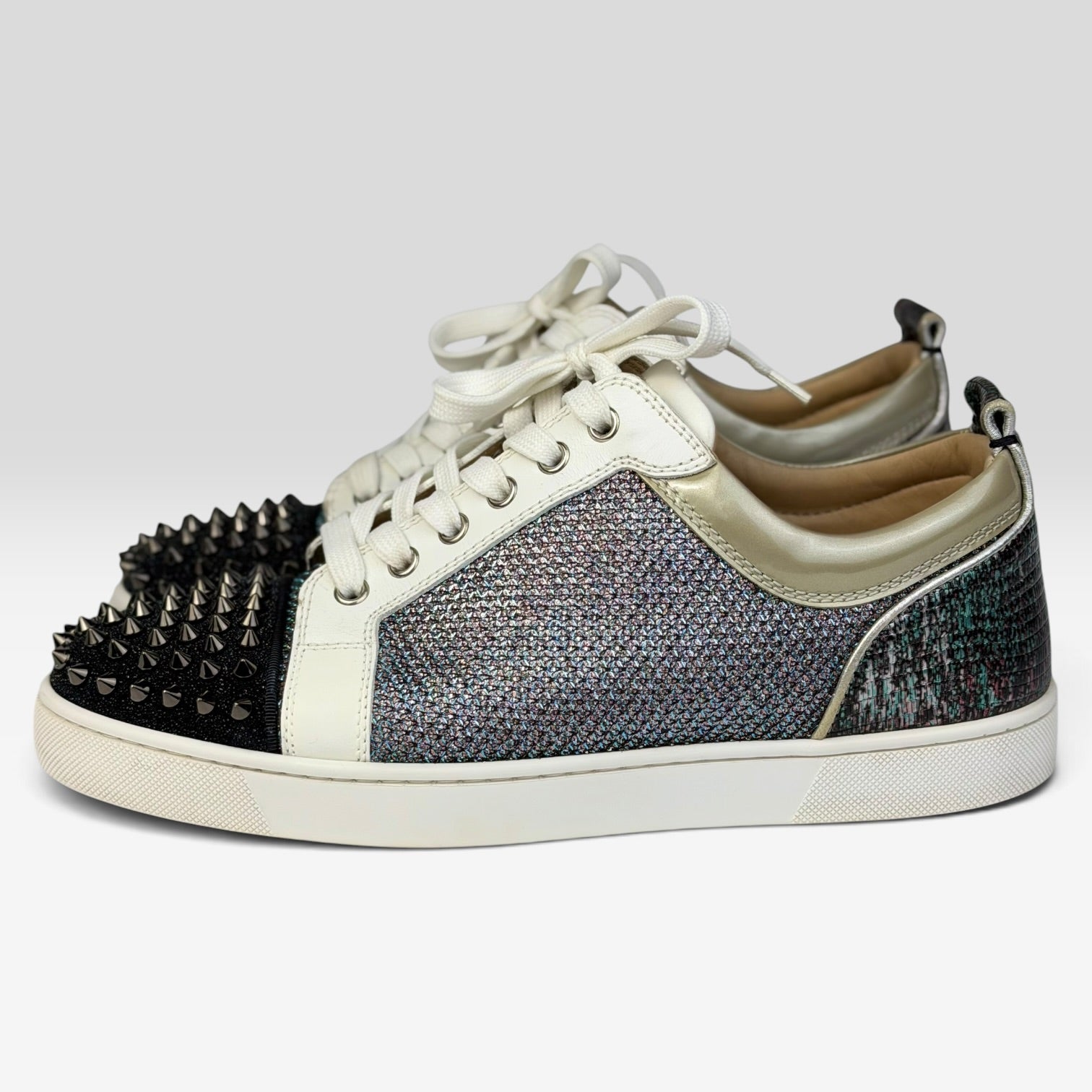 V STEALS Christian Louboutin Louis Junior sneakers with multicolor glitter, lizard-embossed leather, and silver spikes.