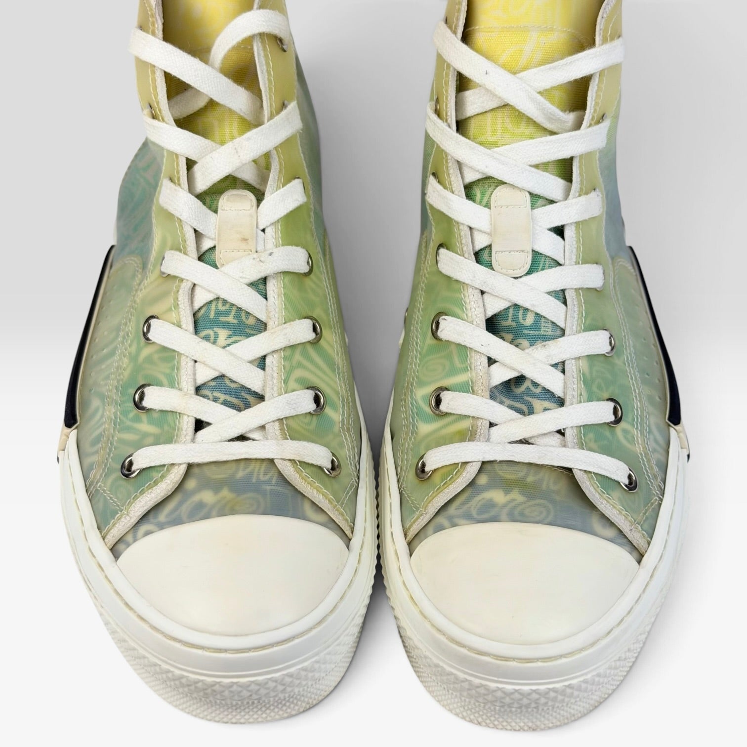 V STEALS Dior x Shawn Stussy B23 high-top sneakers featuring multicolor graphic canvas and transparent panels.