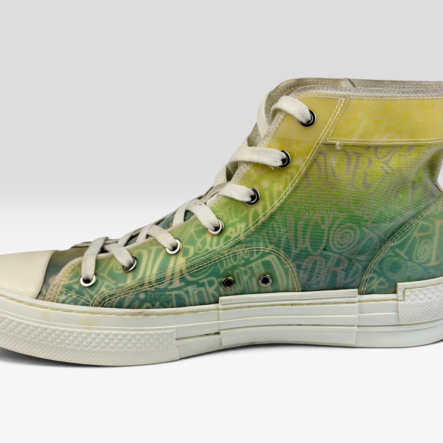 V STEALS Dior x Shawn Stussy B23 high-top sneakers in multicolor canvas with graffiti print and transparent panels.