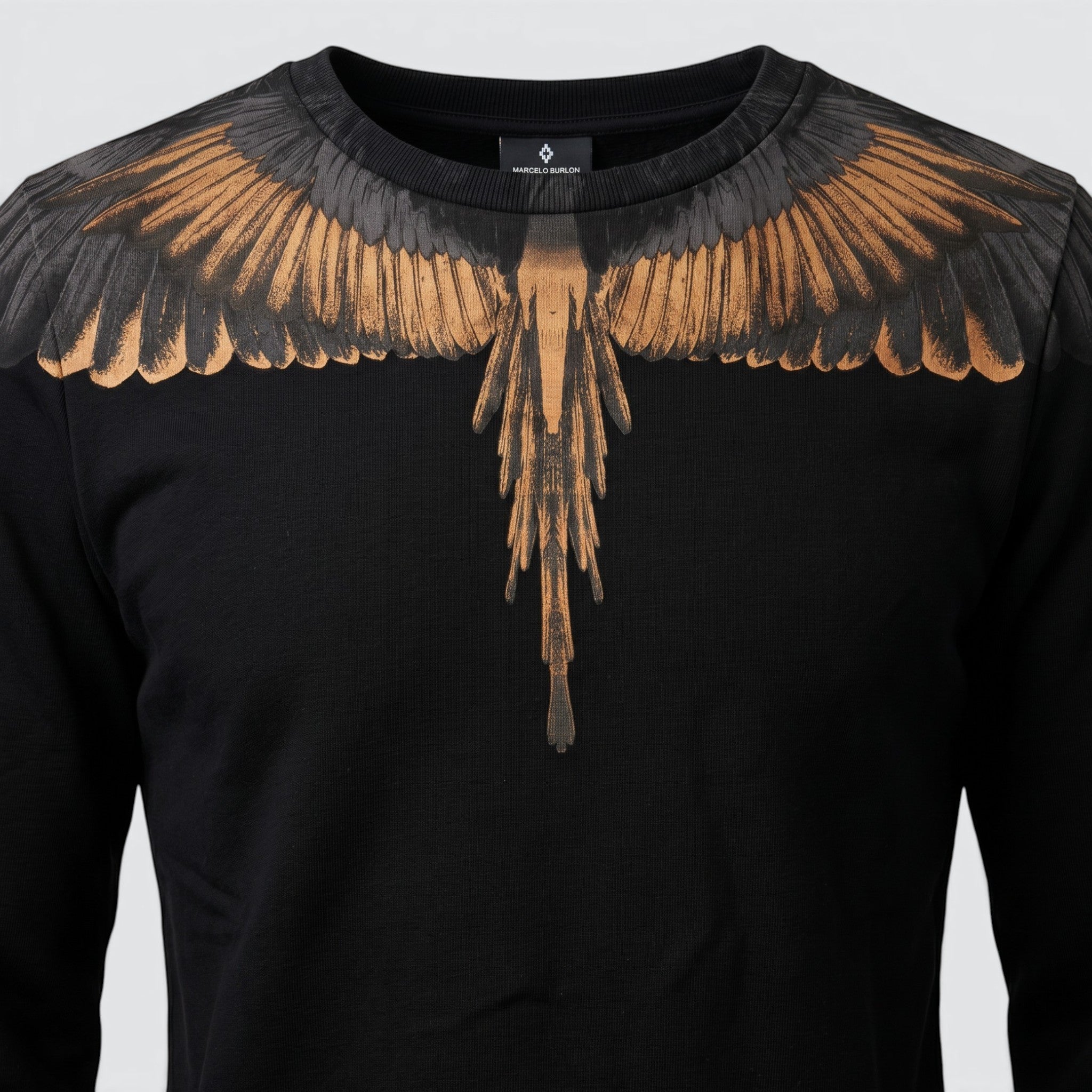 V STEALS Marcelo Burlon black french terry sweatshirt featuring the signature gold and grey wings graphic print