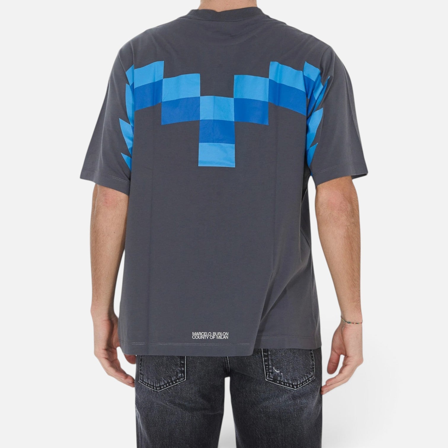 Back view of V STEALS Marcelo Burlon oversized grey cotton t-shirt with blue pixelated wings graphic
