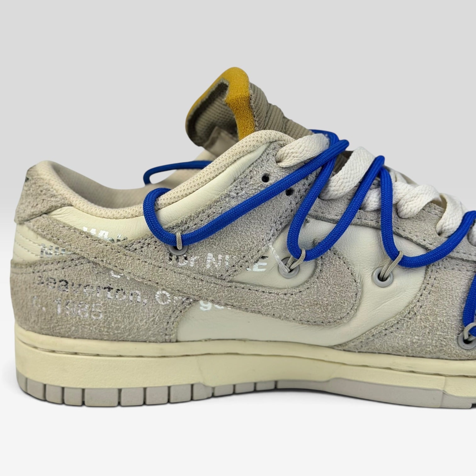 V STEALS Nike x Off-White Dunk Low Lot 32 sneaker featuring grey suede, cream leather, and signature blue lacing.