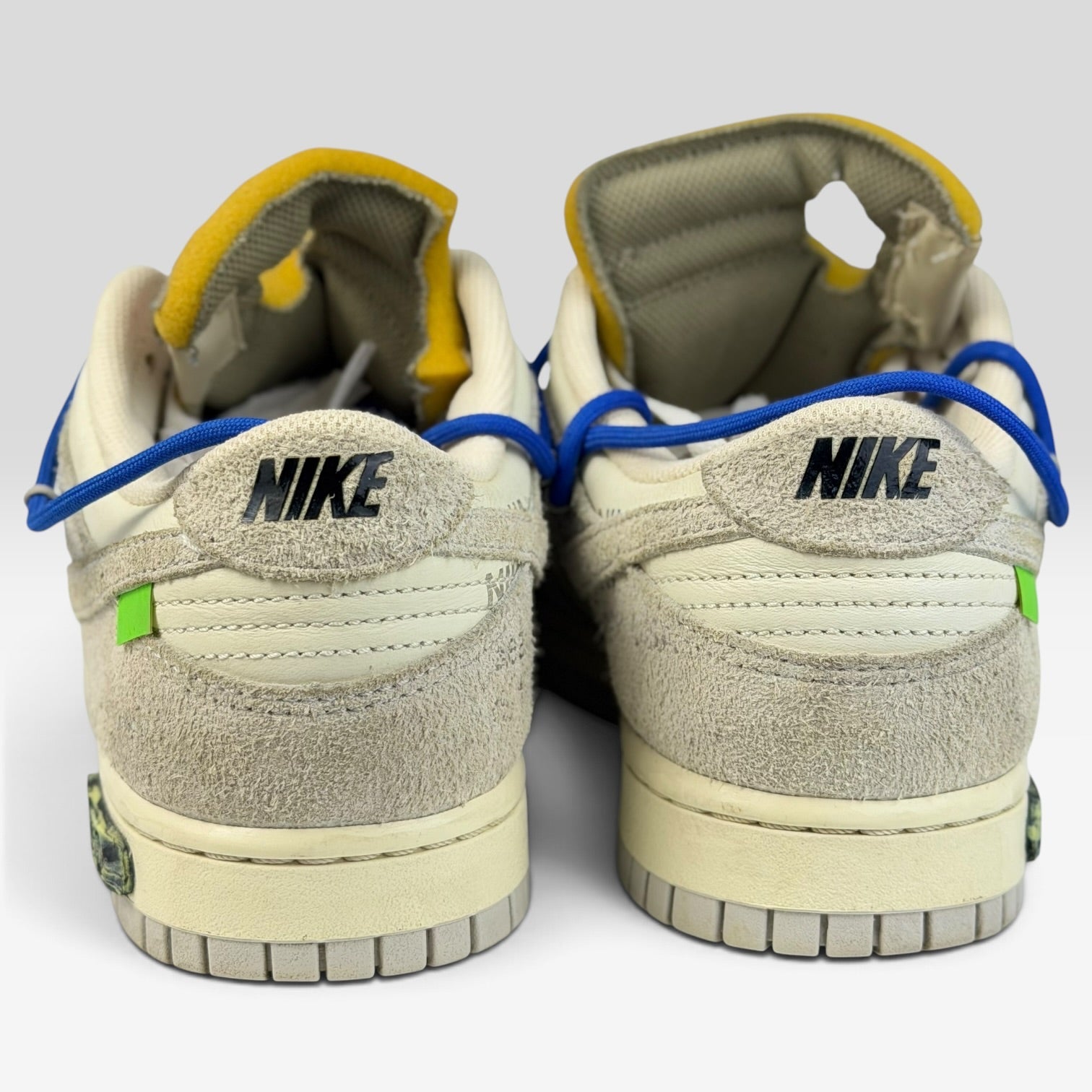 V STEALS Nike x Off-White Dunk Low Lot 32 sneakers showing the heel view with suede details and blue lacing system