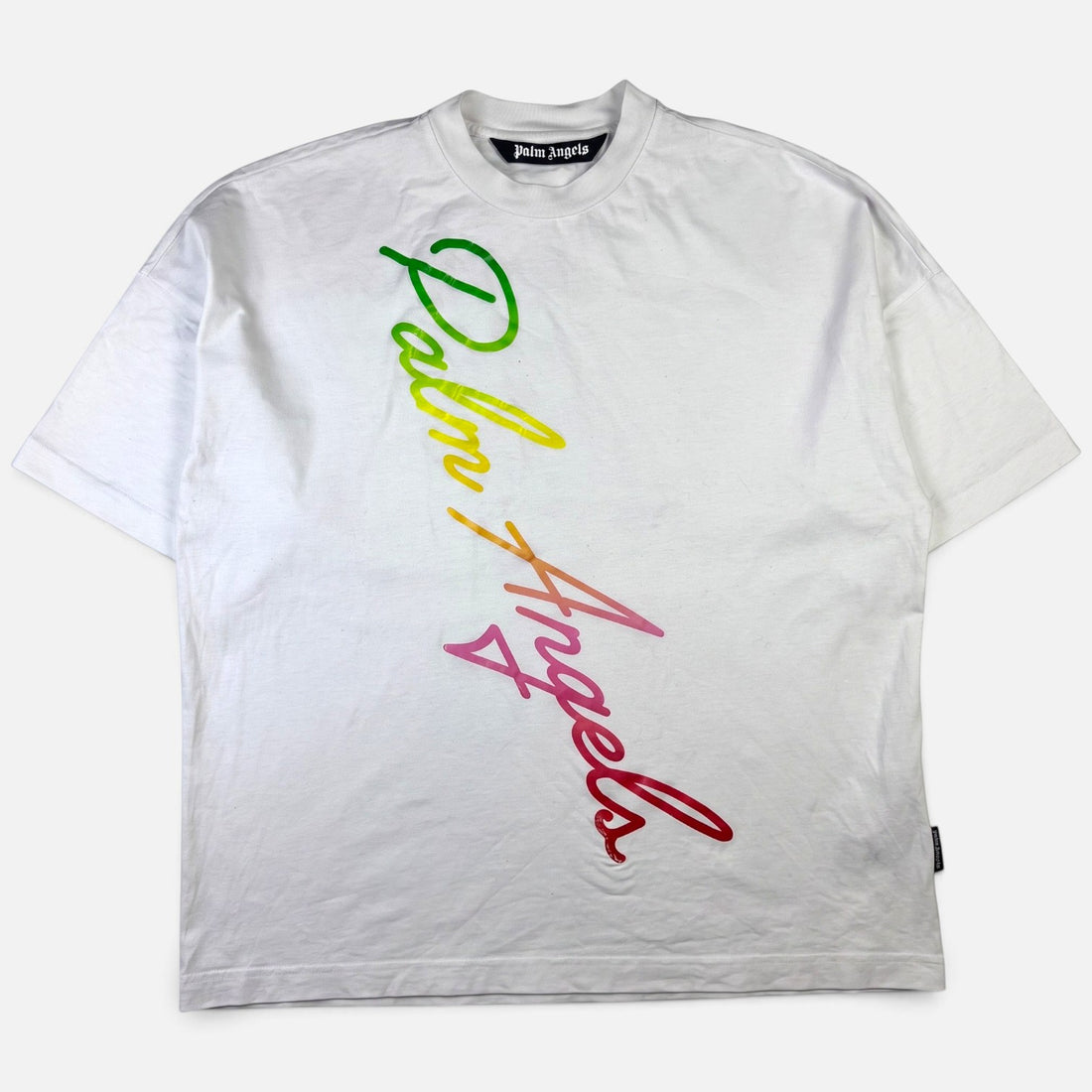V STEALS white cotton t-shirt with a diagonal multicolored gradient cursive Palm Angels logo across the front.