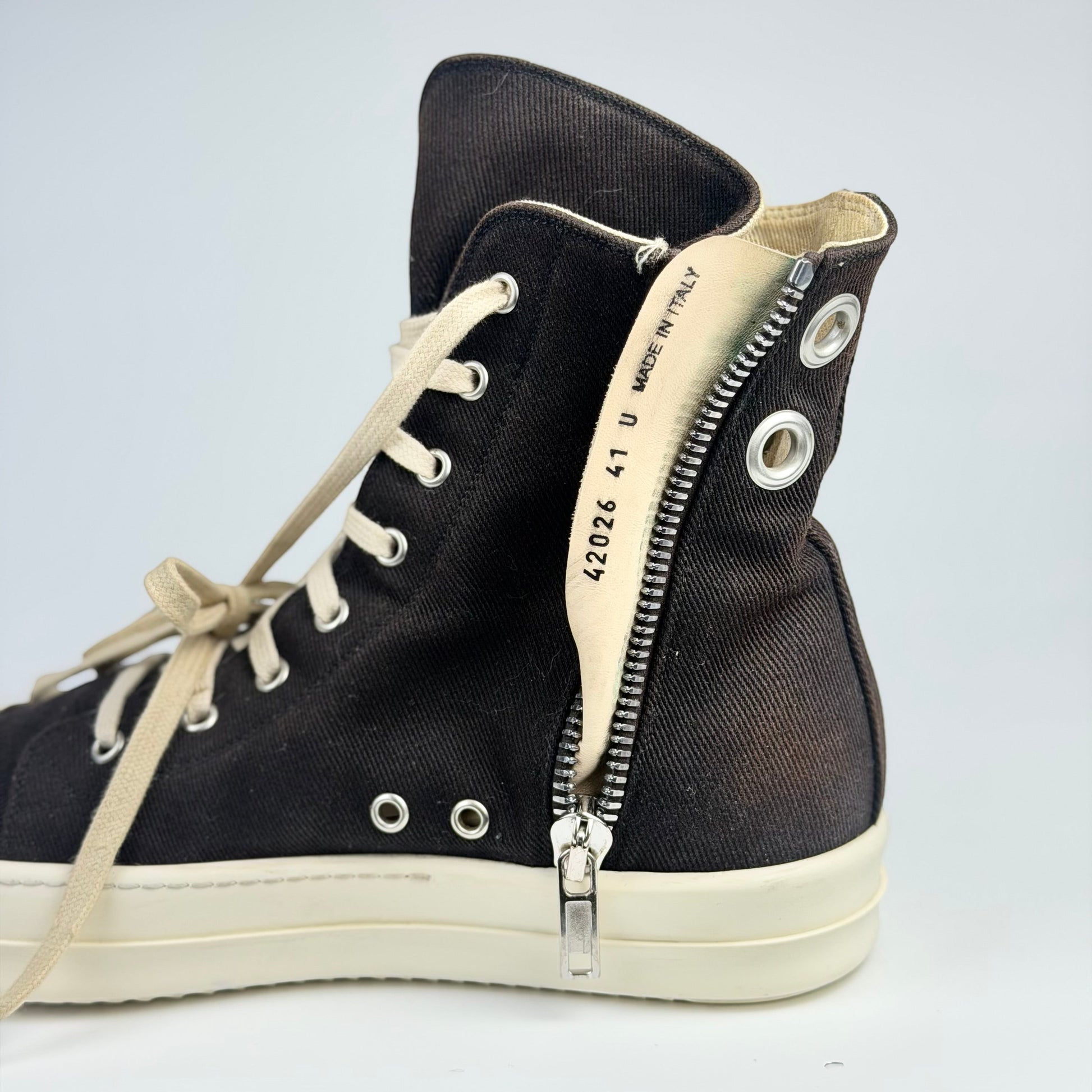 V STEALS Rick Owens Ramones high-top sneakers in black canvas with oversized silver eyelets and side zipper detail.