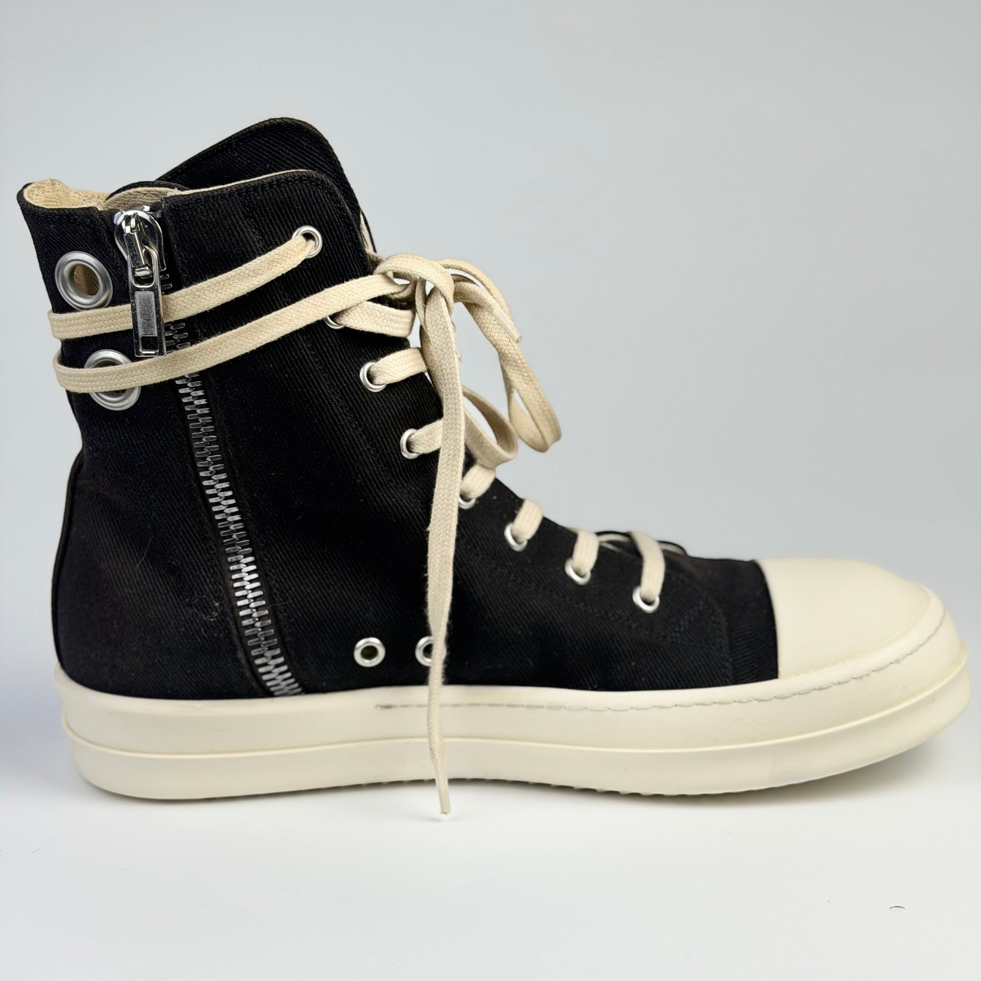 V STEALS Rick Owens Ramones high-top sneakers in black canvas with oversized metal eyelets and white rubber toe cap.