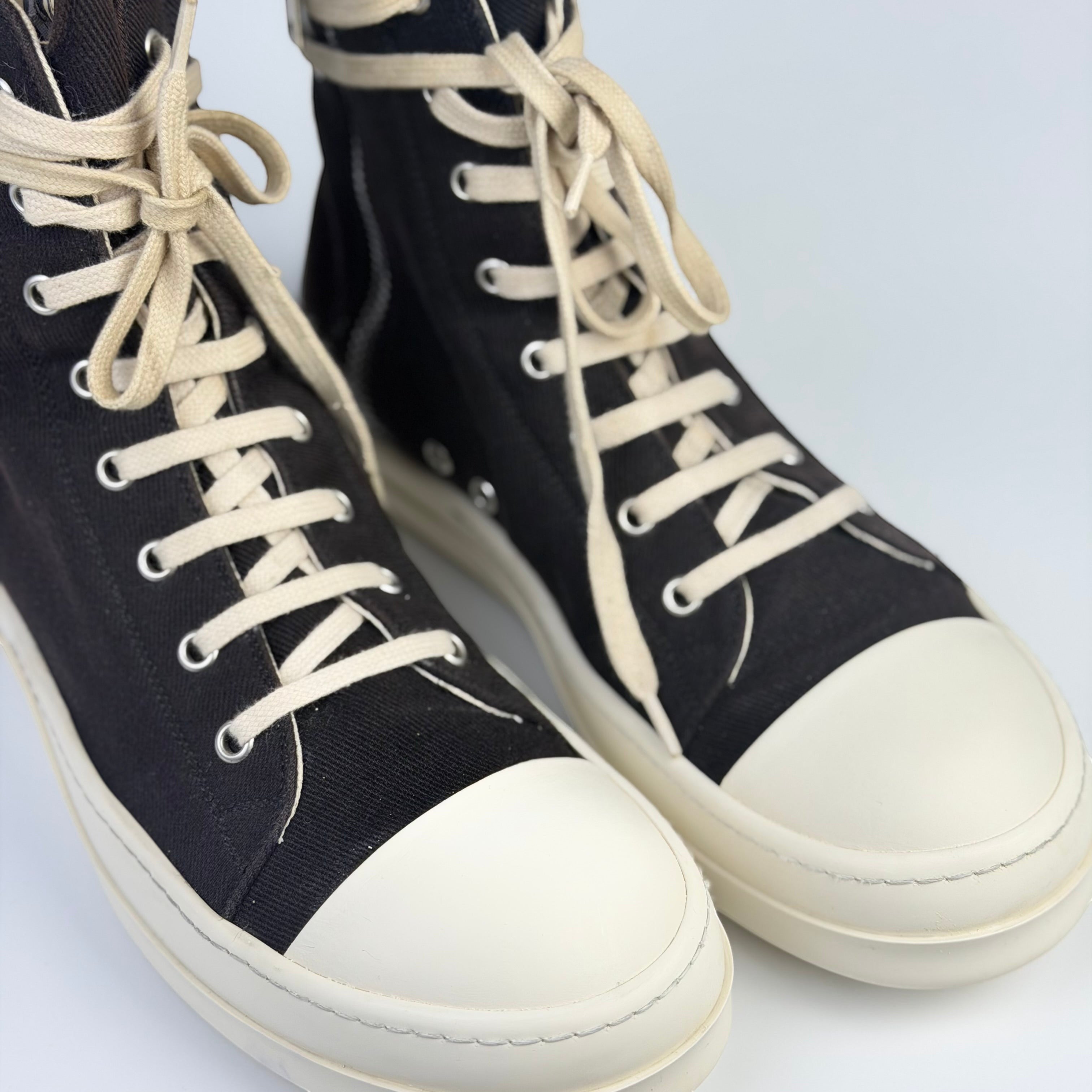 V STEALS Rick Owens Ramones high-top sneakers in black canvas with oversized metal eyelets and white rubber toe caps.